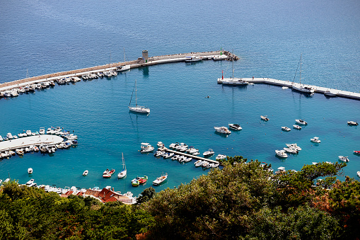 Above view of the harbor in the village of Baška, popular touristic destination on Krk Island in Croatia, Europe. Turquoise blue Adriatic sea off the Croatian coast.