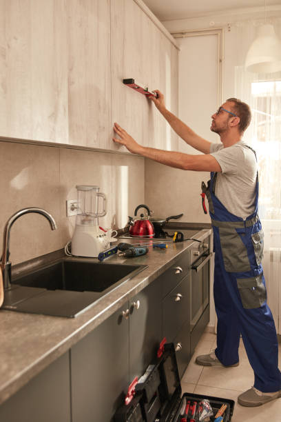 istock Handyman fixing kitchen cabinets in the apartment. 1673908984