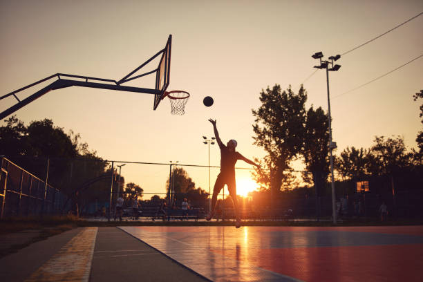 istock Man playing basketball on a public court. 1673909297