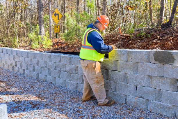 istock During development of new property, construction worker is using cement blocks for building a retaining wall. 1673910578