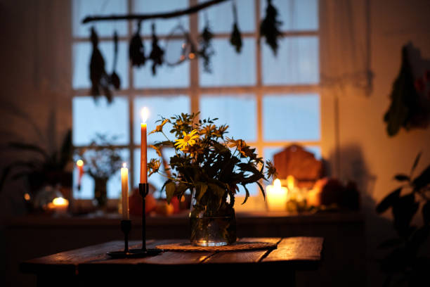 istock Two candlesticks with burning candles standing on wooden table 1673914946