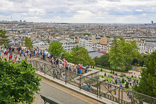 Paris, France - July 13, 2023: Crowd on the steps in front of the Sacre Coeur church in Montmartre