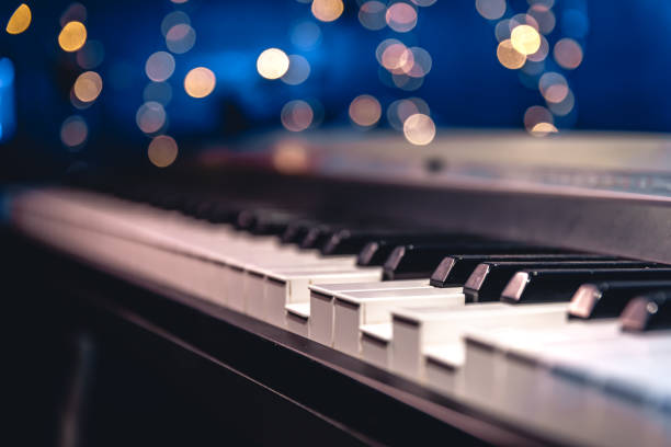 istock Piano keys close-up on a blurred background with bokeh. 1673939530