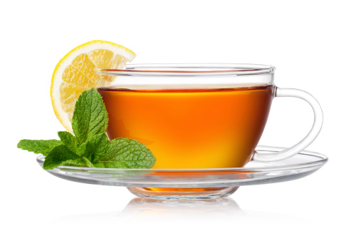 Cup of tea with mint and lemon on a white background