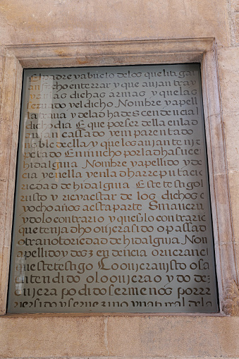 Interior Stained Glass Window with engraved inscriptions in the Spanish Language of the Palau del lloctinent Courtyard, Headquarters of the State Archives and Crown of Aragon in the Gothic Neighborhood, Spain.