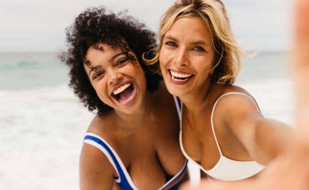 istock Beach selfie vibes: Friends capturing laughter, fun, and authentic moments by the ocean 1673975242