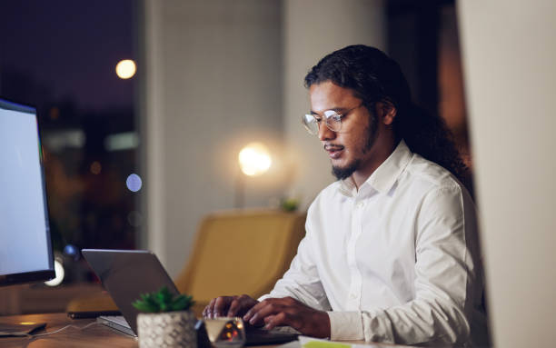istock Night, business and man with laptop, typing and connection with programming, code and trading. Person, investor or accountant with a pc, stock market and data analysis with research, evening and tech 1673976327