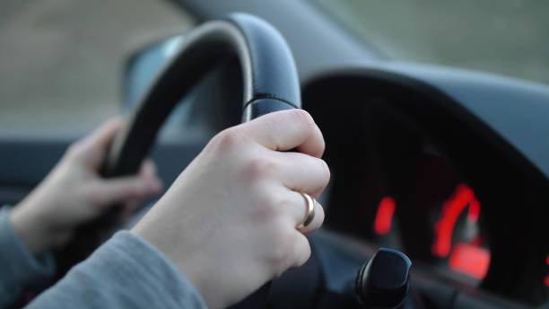 istock Car Dashboard and Female Hands Holding Steering Wheel During Driving 1673976869