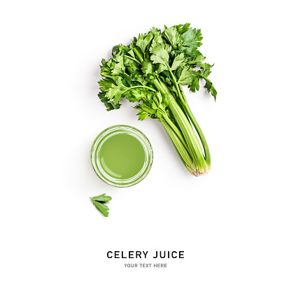 Fresh green celery and glass with celery juice isolated on white background. Creative layout. Healthy eating and dieting food concept. Design element. Top view, flat lay
