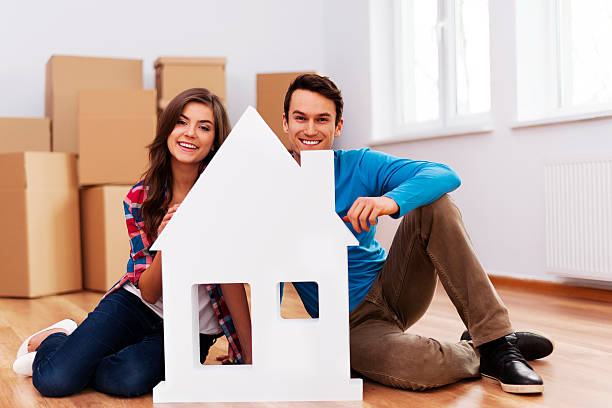 istock Young couple with house sign 167399259