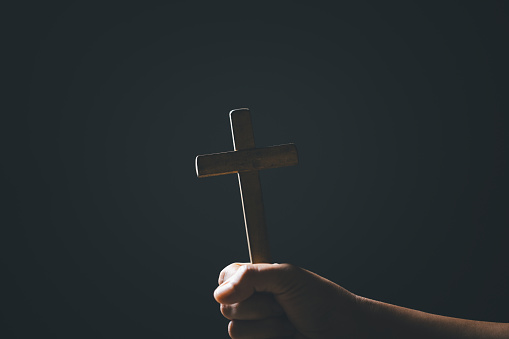 Spirituality, Religion and Hope Concept. Holy bible and cross on desk. Symbol of Humility, Supplication, Believe and Faith for Christian People.