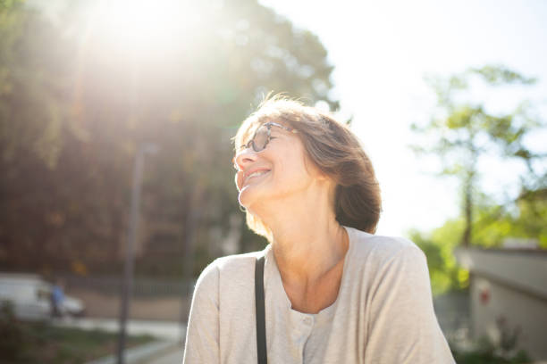 istock Close up older woman with eyeglasses laughing outside 1674014199