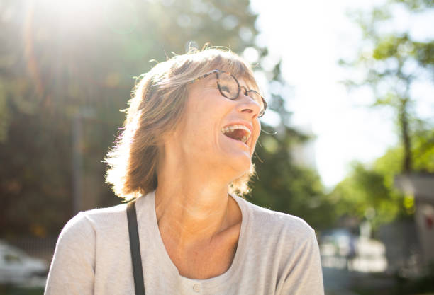 istock Close up laughing older woman with glasses 1674014216