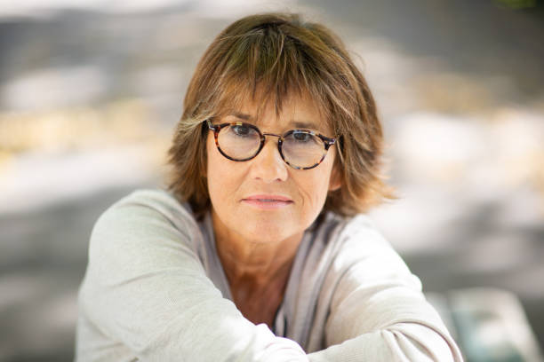istock Close up older woman with eyeglasses staring 1674014227