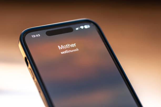 istock Smartphone in child hands with Incoming Mother call on a screen. 1674016381