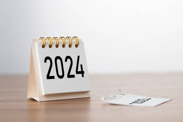 istock 2024 Happy New year background. Turns over a calendar sheet. Setup objective target business cost and budget planning of new year concept. year change from 2023 to 2024. 1674021128
