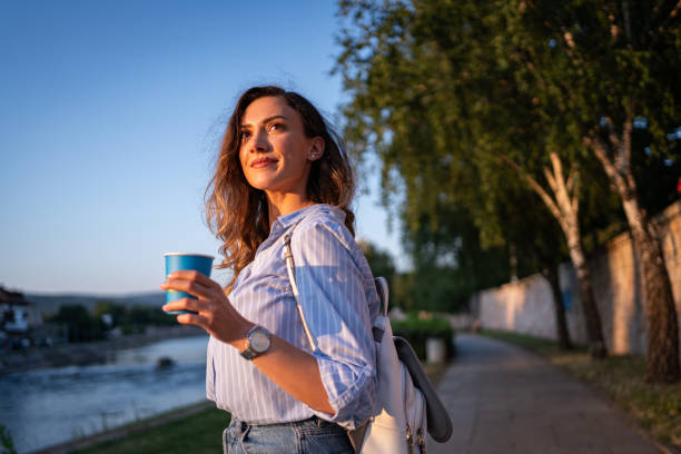 istock Caucasian woman, on a quayside while having a coffee to go 1674022726