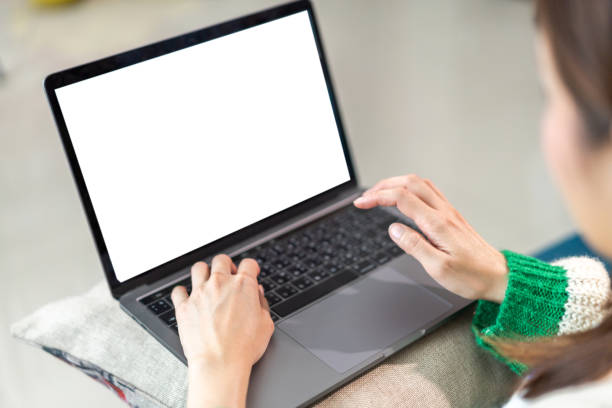 istock Woman working with modern laptop computer blank white desktop screen for advertising, mockup, technology, advertising, search information, creative design on table 1674033115
