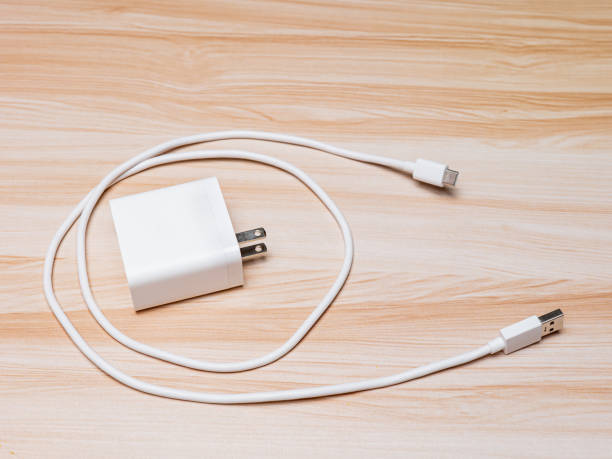 istock USB charger and cable type-C white color on wood table 1674047998