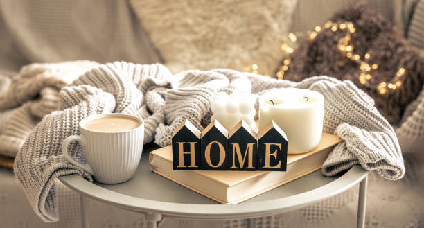 istock Cozy composition with candles, coffee and decorative word home. 1674049740