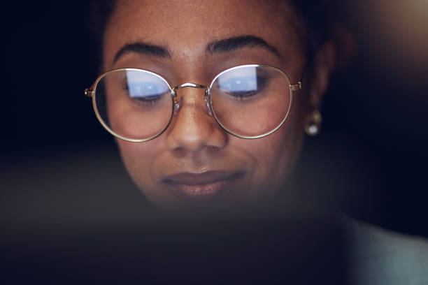 Laptop, student face and night woman reading, studying and learning online information, education or check college database. Analysis, research and closeup person education, working and typing essay