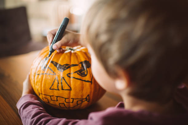 istock Cute little boy preparing for Halloween at home 1674077748