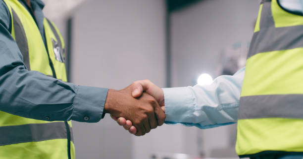 istock Closeup, engineering and men with handshake, agreement and partnership with cooperation, teamwork and thank you. People, architecture or coworkers shaking hands, welcome or collaboration with project 1674077778