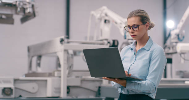 istock Engineer, woman and robotics, laptop and programming of robot arm with machine learning and high tech. Innovation, future technology and engineering, industrial workshop and automation with software 1674077782