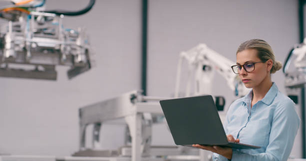 istock Engineering, woman and robotics, laptop and programming of robot, industry 4.0 with machine learning and high tech. Innovation, future technology and engineer, workshop and automation with software 1674077793