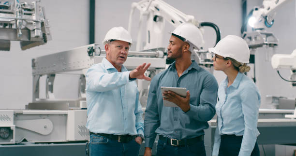 istock Group, speaking and robotics with engineering, tablet and inspection with connection, automation and programming. People, staff or manager with employee, project or tech with productivity or teamwork 1674079363