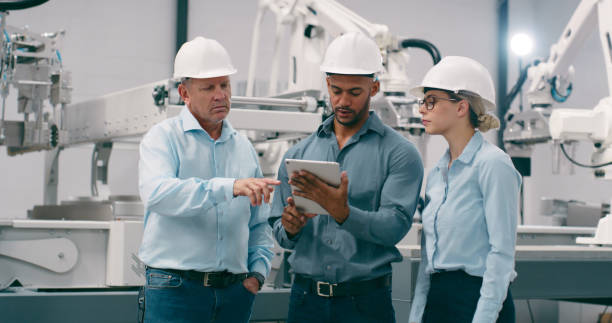 istock Manufacturing, team and robotics with engineering, tablet and productivity with connection, industrial and automation. People, group and manager with employee, machine and technology with programming 1674079893