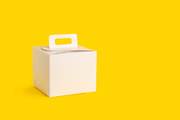 istock A white cardboard box on a yellow background with copy space 1674088235