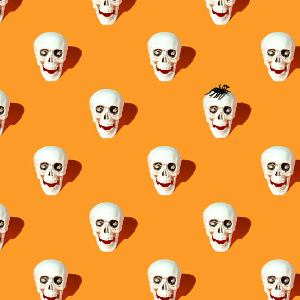 Skull pattern with glasses on pink background. Halloween creative fashion love concept.