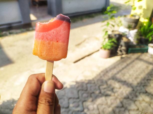 Yellow, orange and purple popsicles had been bitten off the top during the day