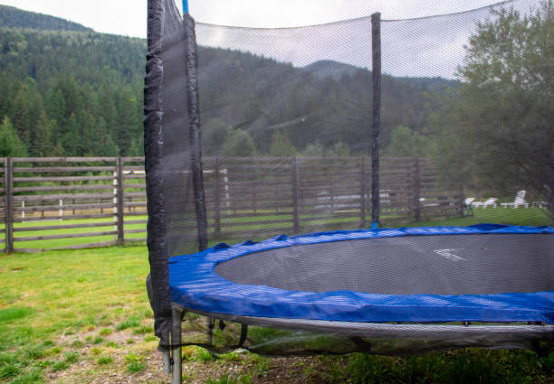 istock Round Trampoline. A Round Trampoline on the Back Yard Grass 1674097467