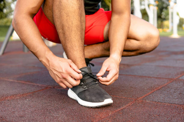 istock Clos-up on Man tying shoelace 1674119127