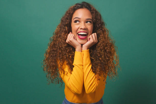 istock Beautiful multi-ethnic woman smiles and laughs, cup hands under chin, studio 1674137206