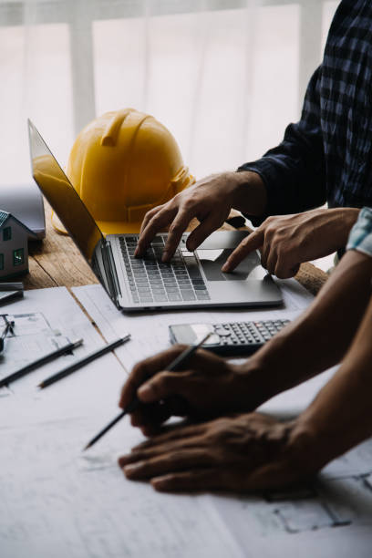 istock Construction and structure concept of engineer working drawing on blueprint meeting for project working with partner on model building and engineering tools in working site, construction concept 1674139550