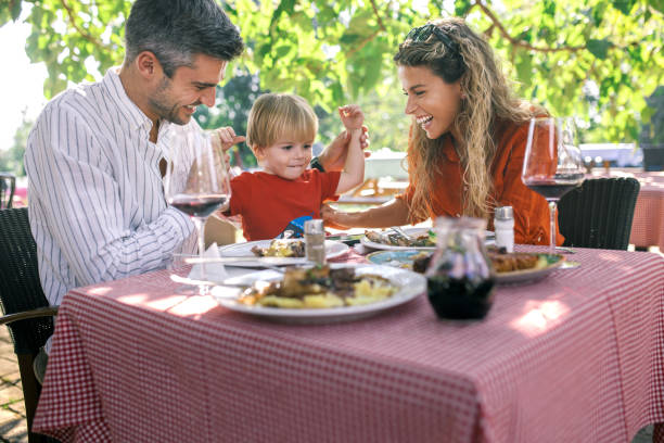 istock a young couple in a restaurant with their child having lunch 1674139752