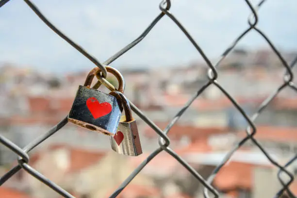 Photo of Locks on the fence of the bridge in lisbon