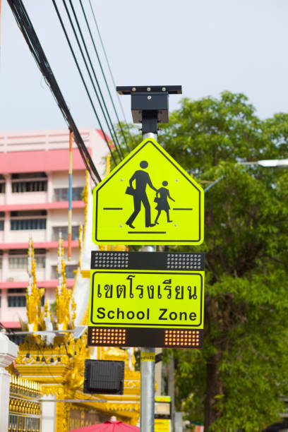 Caution sign for crossing school children at school in Bangkok stock photo