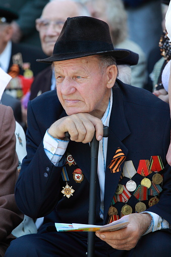 UKRAINE, Romny, May 9, 2010, Victory Day, May 9: Old retired World War II veteran with medals and orders of combat awards. Portrait of an old man with wrinkles.