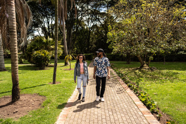 istock Friends talking and walking through the public park 1674160011