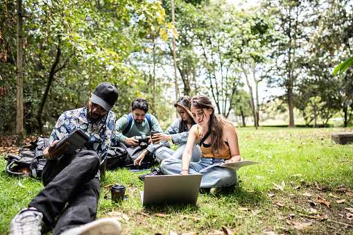 University friends studying together at the public park