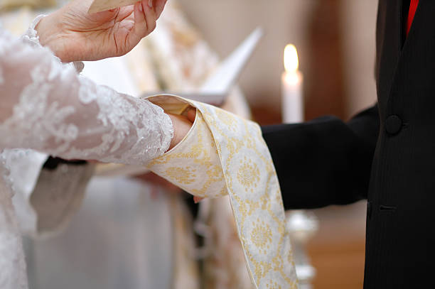 istock Bride and groom's hands, priest's cassock 167417746