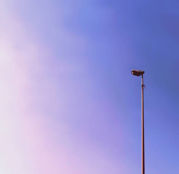This is a minimal photo of a street lamp during a pink and violet sunset