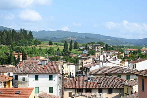 View above the roofs of Greve in Chianti towards the surrounding mountains