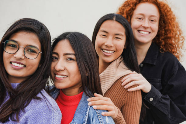 happy young multiracial women smiling in front of camera - concept of diversity and inclusion - focus on the indigenous woman face - life events laughing women latin american and hispanic ethnicity imagens e fotografias de stock