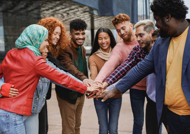 young university students stacking hands together outdoor - multiracial people and community concept - life events laughing women latin american and hispanic ethnicity imagens e fotografias de stock