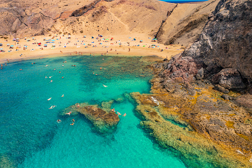 Aerial photo from a drone of the popular tourist 'Papagayo Beach' on Lanzarote's South Coast, Canary Islands, Spain. Captured in September 2023.